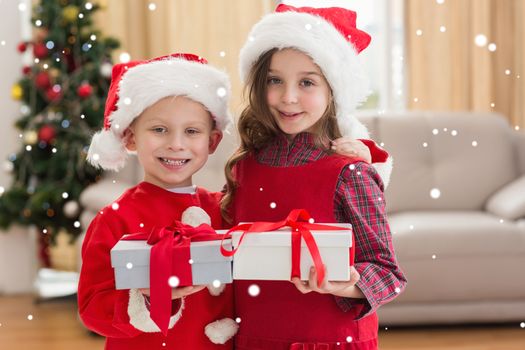 Composite image of festive little siblings holding gifts