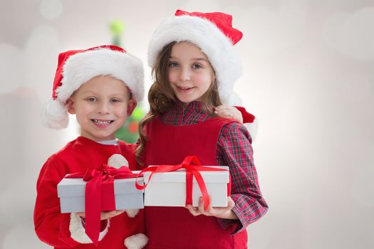 Composite image of cute siblings with gifts