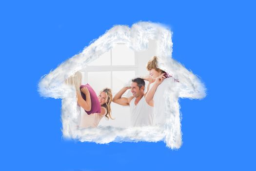 Composite image of family having fun with pillows 