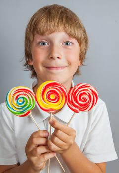 child boy eating lollipop