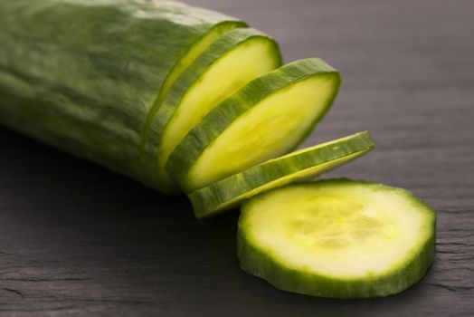 cucumber slices on on black plate