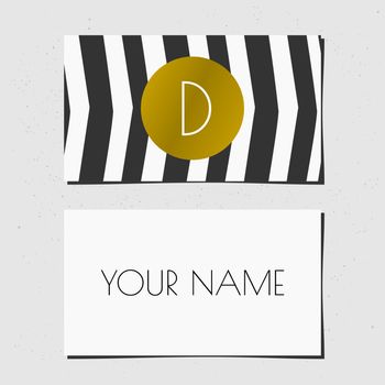 Modern business card template design. Golden circle with monogram letter on a black and white chevron background.