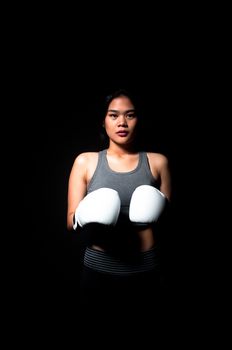 Asian female boxer on black background
