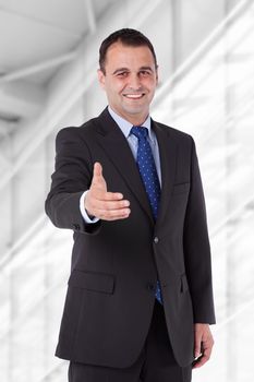 Businessman in a suit reaching hand for handshake. Isolated with work path.