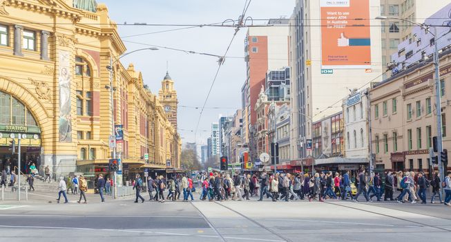 Busy crosswalk outside Flinders Street Station in Melbourne