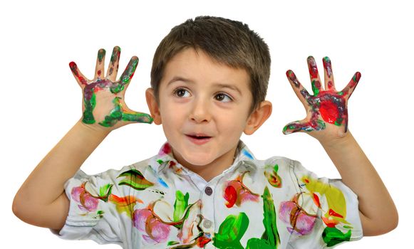 Little boy painting with hands with different color paint on his palms
