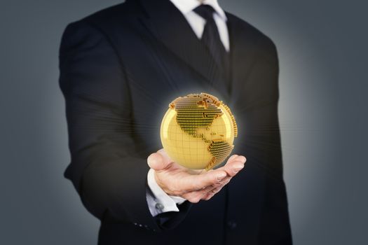 Businessman holding a golden globe