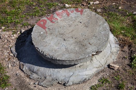 Manhole with the concrete cover on the concrete basement
