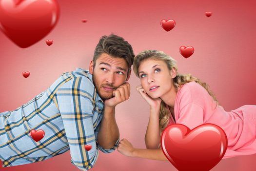 Composite image of attractive young couple lying and thinking
