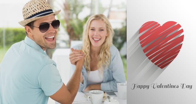 Hip young couple having coffee together  against cute valentines message