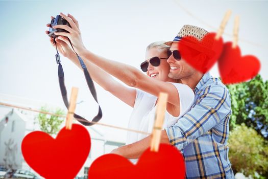 Composite image of stylish young couple taking a selfie