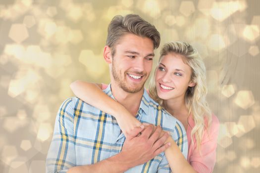 Attractive couple embracing and smiling against light glowing dots design pattern