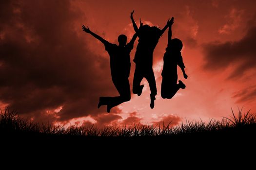 Composite image of silhouette of people jumping