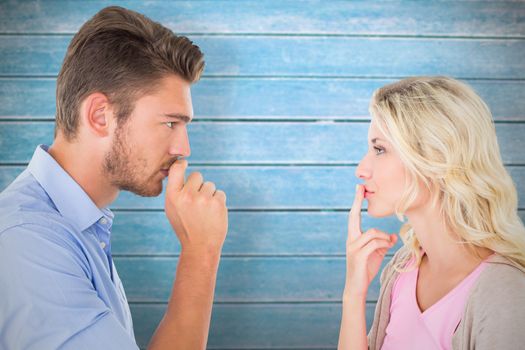 Composite image of young couple staying silent with fingers on lips