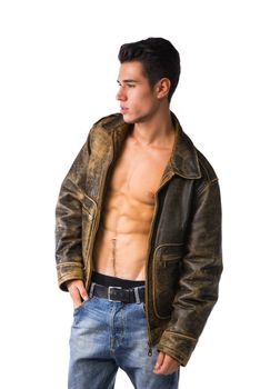 Handsome young man wearing leather jacket on naked torso, isolated
