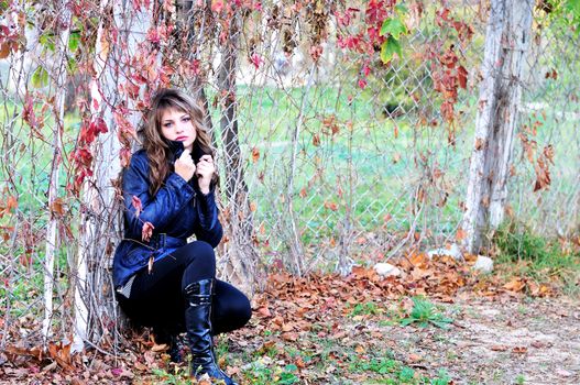 pensive autumn teen girl wearing leather lacket