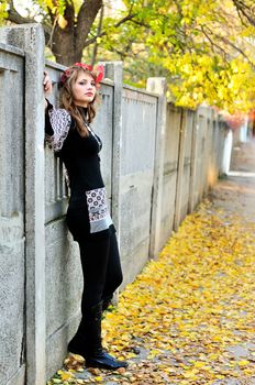 teen girl standing on the autumn parkway
