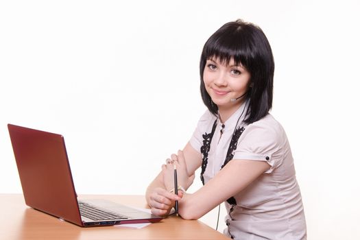 Smiling girl - call-center employee at the desk