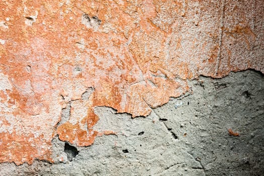 Concrete surface with the remains of orange paint and whitewash 