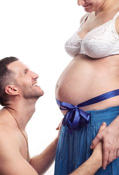 Cheerful young man looking at his pregnant wife