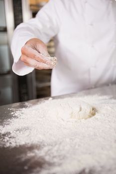 Close up of dough with flour on worktop