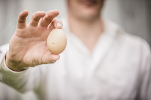 Farmer Showing an Egg