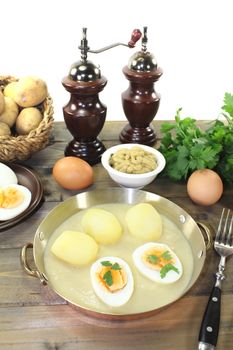 fresh sharp mustard eggs with sauce and potatoes