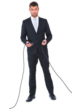 Businessman connecting cables together