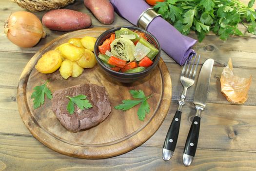 roasted ostrich steak with baked potatoes