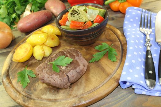 roasted ostrich steak with baked potatoes and parsley