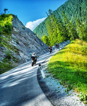 Bikers tour along Alps
