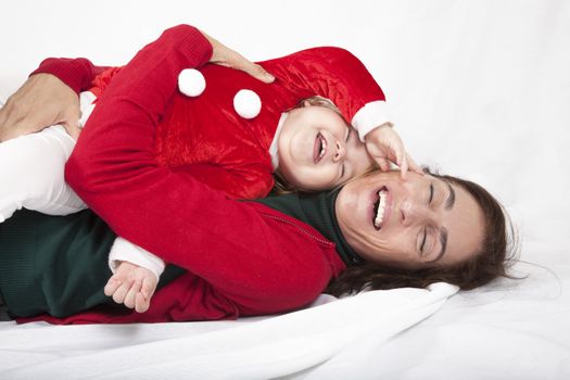 baby santa claus laughing with mother