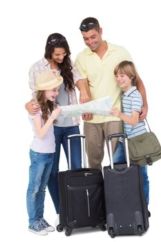 Family with luggage exploring map