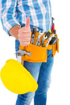 Midsection of manual worker gesturing thumbs up