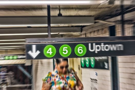 Blurred image of people walking in New York subway