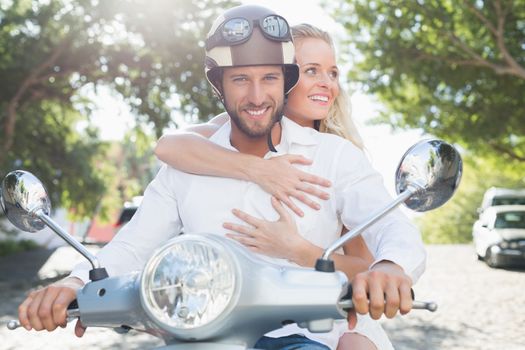 Attractive couple with their scooter