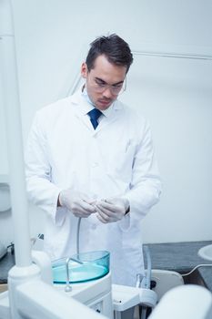 Portrait of male dentist holding dental drill