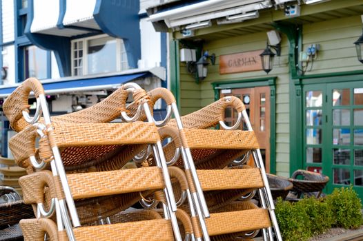Stack of Chairs Outside a Quayside Resaurant on the Waterfront i