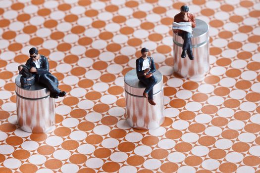Miniature people sitting over a roadmap