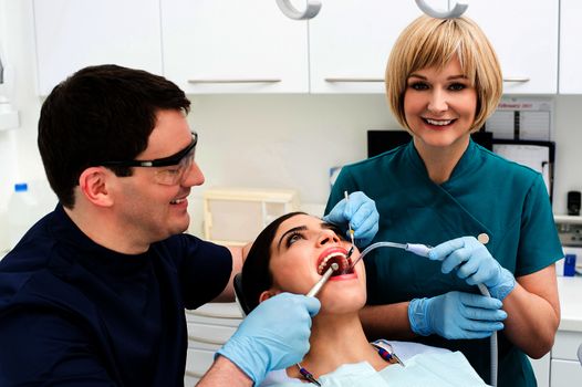 Male dentist treat the female patient