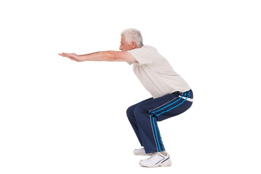 Senior man doing a squat