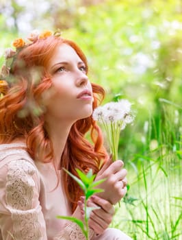 Dreamy woman with dandelions 