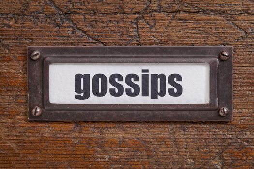 gossips - file cabinet label, bronze holder against grunge and scratched wood