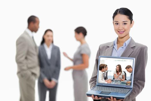Composite image of glad businesswoman talking to her team