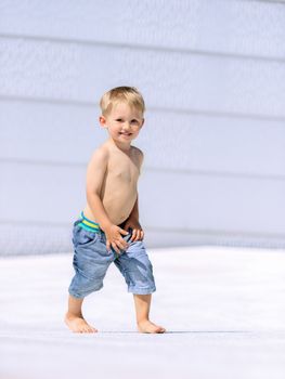 Portrait of little preschool boy outdoors walking