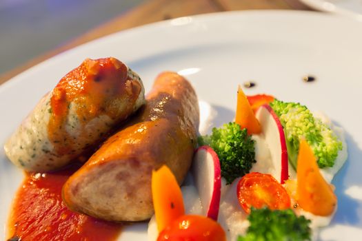 Grilled Mixed German Sausages on white plate for Main Dishes