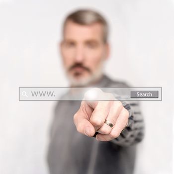 Man pointing at search bar on virtual screen