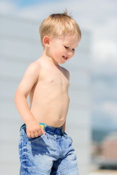Portrait of little preschool boy outdoors smiling