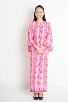 Asian woman in pink batik dress