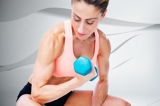 Composite image of strong woman doing bicep curl with blue dumbbell